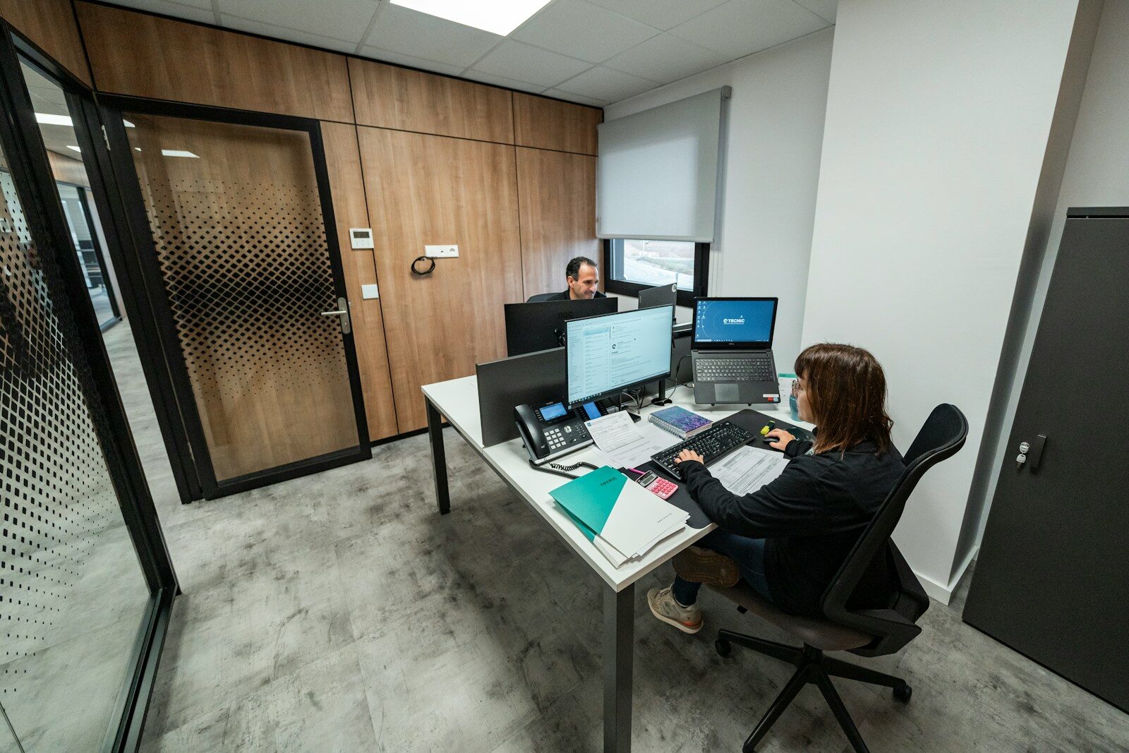 People work at desks in a modern office
